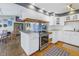 Bright kitchen with stainless steel oven and range, white cabinetry, and adjacent dining area at 540 Villagrande S Ave, St Petersburg, FL 33707