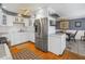 Modern kitchen featuring white cabinets, stainless steel refrigerator, and views into dining room at 540 Villagrande S Ave, St Petersburg, FL 33707