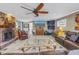 Spacious living room with tile flooring, brick fireplace, and a modern ceiling fan at 540 Villagrande S Ave, St Petersburg, FL 33707