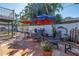 Inviting outdoor patio with tile flooring, comfortable seating, BBQ grill, and lush tropical landscaping at 540 Villagrande S Ave, St Petersburg, FL 33707