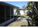 View of the backyard, partially covered patio, walkway and white fence providing an inviting outdoor space at 5532 War Admiral Dr, Wesley Chapel, FL 33544