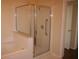 Bathroom showcasing a glass-enclosed shower, separate bathtub, and tile flooring at 5532 War Admiral Dr, Wesley Chapel, FL 33544