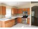 Modern kitchen featuring stainless steel appliances, tile backsplash, and functional layout at 5532 War Admiral Dr, Wesley Chapel, FL 33544