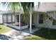 Covered and screened-in patio with stone floor tiles, ideal for outdoor entertaining and relaxation at 5532 War Admiral Dr, Wesley Chapel, FL 33544