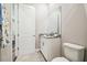 Bright bathroom featuring a granite counter, a large mirror, and a toilet at 5644 Missouri Ave, New Port Richey, FL 34652