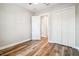 Spacious bedroom featuring luxury vinyl plank flooring, a closet, and a door to the hallway at 5644 Missouri Ave, New Port Richey, FL 34652