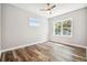 Bedroom featuring hardwood floors and a large window at 5644 Missouri Ave, New Port Richey, FL 34652