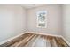 Bedroom features light-colored walls, natural light, and wood-look flooring at 5644 Missouri Ave, New Port Richey, FL 34652