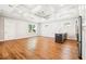 Bright living room features hardwood floors, coffered ceiling with fan, and modern finishes at 5644 Missouri Ave, New Port Richey, FL 34652