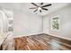 Bright living room with wood floors, a modern ceiling fan, and an abundance of natural light at 5644 Missouri Ave, New Port Richey, FL 34652