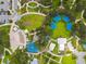 Overhead shot of a park featuring covered picnic areas, playground, and walking paths surrounded by greenery at 5644 Missouri Ave, New Port Richey, FL 34652