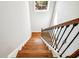 Staircase with wood steps and decorative wrought iron railing under skylight at 5644 Missouri Ave, New Port Richey, FL 34652