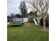 Grass yard with trampoline and playset for children at 568 Seacrest Dr, Largo, FL 33771