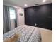 Bedroom with a full-size bed and a black accent wall at 568 Seacrest Dr, Largo, FL 33771