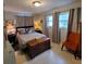 Spacious bedroom with a queen-size bed and an accent chair at 568 Seacrest Dr, Largo, FL 33771