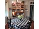 Bright dining area with round table, black and white checkered tablecloth, and a hutch at 568 Seacrest Dr, Largo, FL 33771