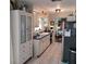 White kitchen cabinets, stainless steel appliances, and a large pantry at 568 Seacrest Dr, Largo, FL 33771