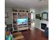 Living room with built-in shelving, hardwood floors, and a fireplace at 568 Seacrest Dr, Largo, FL 33771