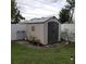 Beige storage shed with dark gray double doors at 568 Seacrest Dr, Largo, FL 33771