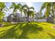 Relaxing pool area with screened enclosure and grassy backyard at 5720 Venetian Ne Blvd, St Petersburg, FL 33703