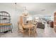 Dining room with chandelier and wood table with wicker chairs at 6075 Shore S Blvd # 103, Gulfport, FL 33707