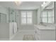 Elegant bathroom with a walk-in shower, marble vanity, and window with shutters at 620 26Th N Ave, St Petersburg, FL 33704