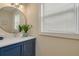 Modern bathroom with blue vanity and a large mirror at 620 26Th N Ave, St Petersburg, FL 33704