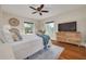 Bright bedroom with hardwood floors, a ceiling fan, and a dresser at 620 26Th N Ave, St Petersburg, FL 33704