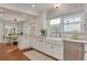 White kitchen with farmhouse sink, stainless steel appliances, and granite countertops at 620 26Th N Ave, St Petersburg, FL 33704