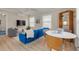 Bright living room features stylish blue sofa and dining area at 620 26Th N Ave, St Petersburg, FL 33704