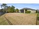 Spacious backyard with grassy lawn and view of house at 6230 Plover Meadow St, Lithia, FL 33547