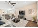 Open living room featuring hardwood floors and a large TV at 6230 Plover Meadow St, Lithia, FL 33547