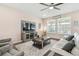 Living room with hardwood floors, comfortable seating, and a large TV at 6230 Plover Meadow St, Lithia, FL 33547