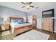 Spacious bedroom with wood furniture and a ceiling fan at 6230 Plover Meadow St, Lithia, FL 33547