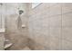 Modern shower with tile surround and rainfall shower head at 6230 Plover Meadow St, Lithia, FL 33547