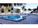 Community pool with surrounding patio furniture at 6322 Palma Del Mar S Blvd # 401, Tierra Verde, FL 33715