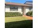 Exterior view of a single-story home with a well-maintained lawn at 7947 Radcliffe Cir, Port Richey, FL 34668