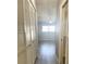 Bright hallway with access to bedroom and bathroom at 7947 Radcliffe Cir, Port Richey, FL 34668