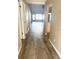 Hallway with wood-look flooring leading to other rooms at 7947 Radcliffe Cir, Port Richey, FL 34668