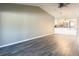 Living room with vinyl flooring and a view of the kitchen at 7947 Radcliffe Cir, Port Richey, FL 34668