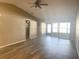 Living room with high ceilings, wood-look floors, and sliding doors to lanai at 7947 Radcliffe Cir, Port Richey, FL 34668