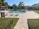 Community pool with lounge chairs and patio tables at 7947 Radcliffe Cir, Port Richey, FL 34668