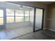 Sunroom with sliding glass doors and grey flooring at 7947 Radcliffe Cir, Port Richey, FL 34668