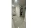 Clean hallway with tile flooring and multiple doors at 8303 Begonia St, Spring Hill, FL 34608