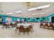 Large community room with tables, chairs, and a stage at 9548 141St St, Seminole, FL 33776