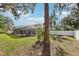 Spacious backyard with lush lawn and screened pool enclosure at 1010 Emerald Creek Dr, Valrico, FL 33596