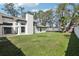 Expansive backyard with grassy lawn and partial home view at 1010 Emerald Creek Dr, Valrico, FL 33596