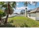 Large grassy backyard with mature trees and privacy fence at 1010 Emerald Creek Dr, Valrico, FL 33596