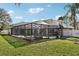 View of the home's backyard with a screened pool and patio at 1010 Emerald Creek Dr, Valrico, FL 33596