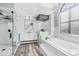 Spa-like bathroom featuring a soaking tub, walk-in shower, and modern vanity at 1010 Emerald Creek Dr, Valrico, FL 33596